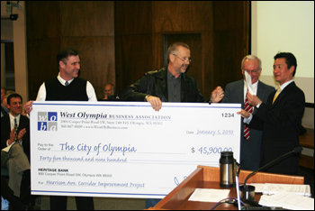 WOBA hands over a big check to the City of Olympia for the WOBA contribution for the completion of the Harrison/Mud Bay Rd Improvements.